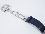 a close up of a watch on a white surface with a blue strap