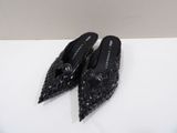 the black shoes are sitting on the white surface