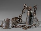 two bells and a chain on a table