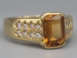 une image représentant une bague en or sertie d'une grosse citrine entourée de petits diamants