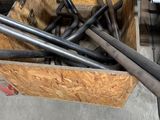 a box full of metal pipes in a room
