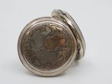 a close up of a silver ring with a coin on it