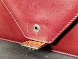 a close up of a red purse with a metal clasp