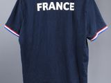 a t - shirt with the word france on it hanging on a hanger