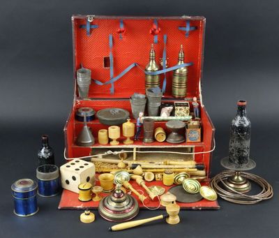a red suitcase with various items in it on a table