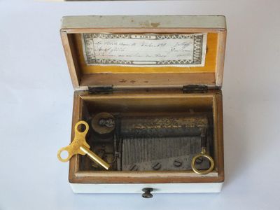 a wooden box with a musical box inside of it