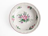 a white plate with a pink flower design on it