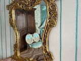 a mirror on the wall above a dresser in a room