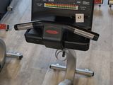 an image of a gym room with a tread machine and a monitor