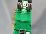 a green toy truck that is sitting on a table