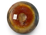 a brown and yellow vase with a tag on it