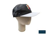 the hat is black and white with a red and yellow bird on it