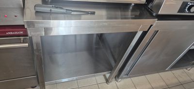 stainless steel ovens in a commercial kitchen with tiled flooring
