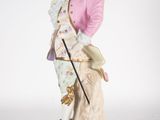 an image of a figurine of a man in a pink coat holding a cane