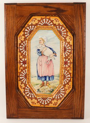 an old picture of a woman in a pink dress is hanging on a wall