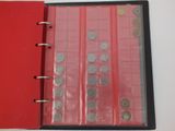 a red binder with coins in it on a table