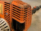 an orange and black blower sitting on the floor