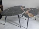 two tables that are sitting side by side on the floor