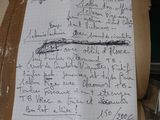 a piece of paper with writing on it sitting on top of a table