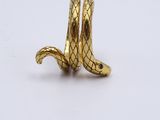an image of a gold snake ring on a white surface
