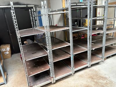 many shelves that are in a room with boxes on them