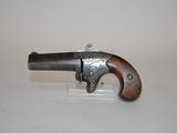 an old gun with a wooden handle on a white surface