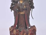 statue of a woman holding a bird on a stand