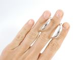 a woman ' s hand with two rings on her fingers