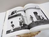 an open book with a black and white photo of a group of people playing baseball