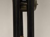 a black and gold clock sitting on a white table