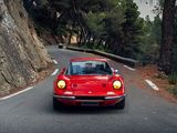 a red car that is driving down the road