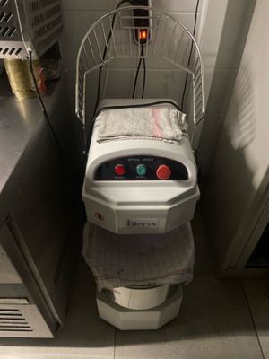 a toilet with a basket on top of it next to a sink
