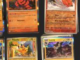 several different pokemon cards are displayed on a black surface