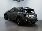 the back end of a grey suv parked in a garage