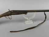 an old rifle with a wooden barrel on a white background