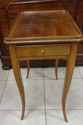 a small wooden table with a drawer underneath it