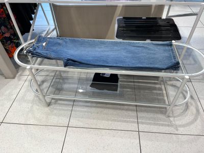 a metal bench with a blue towel on it in a store