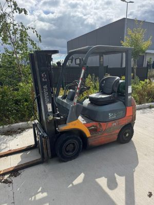 a picture of a forklift parked in front of a building