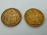 two gold sovereigns, one of which is a woman and one of which is a man