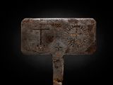 a close up of a metal hammer with a design on it
