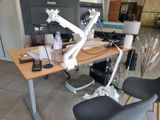a desk with a chair and a computer on it