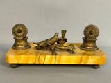 an antique brass figurine of two birds on a marble base