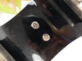 a close up of a metal object with two buttons on it