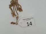 a close up of a gold chain with a tag on it