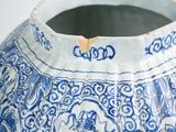 a blue and white vase with a floral design on it