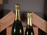 two bottles of champagne sitting next to each other on a table