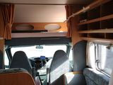 a view of the inside of a camper with a bunk bed
