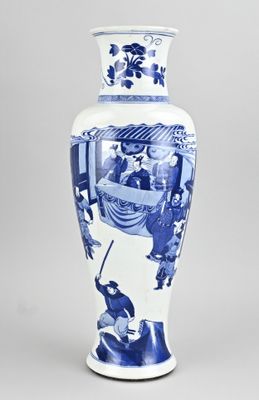 a blue and white vase with a picture of people on it