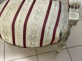 a chair that has a stripped seat and a red and white stripe seat
