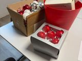 a table with a box of christmas ornaments and a box of ornaments on it
